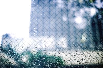 Close-up of wet glass window during monsoon