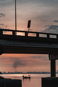 Fisherman fishing under the penang bridge, penang, malaysia.