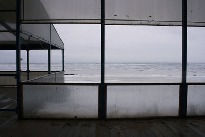 Scenic view of sea seen through glass window