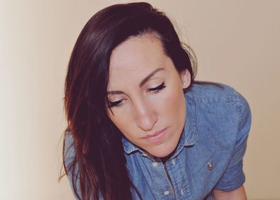 Portrait of beautiful young woman against white background
