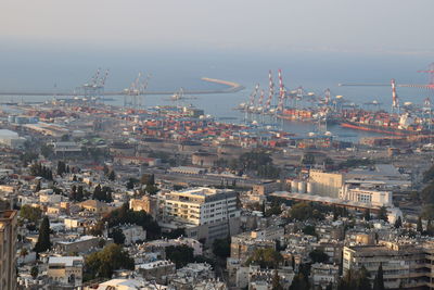 High angle view of townscape by sea against sky