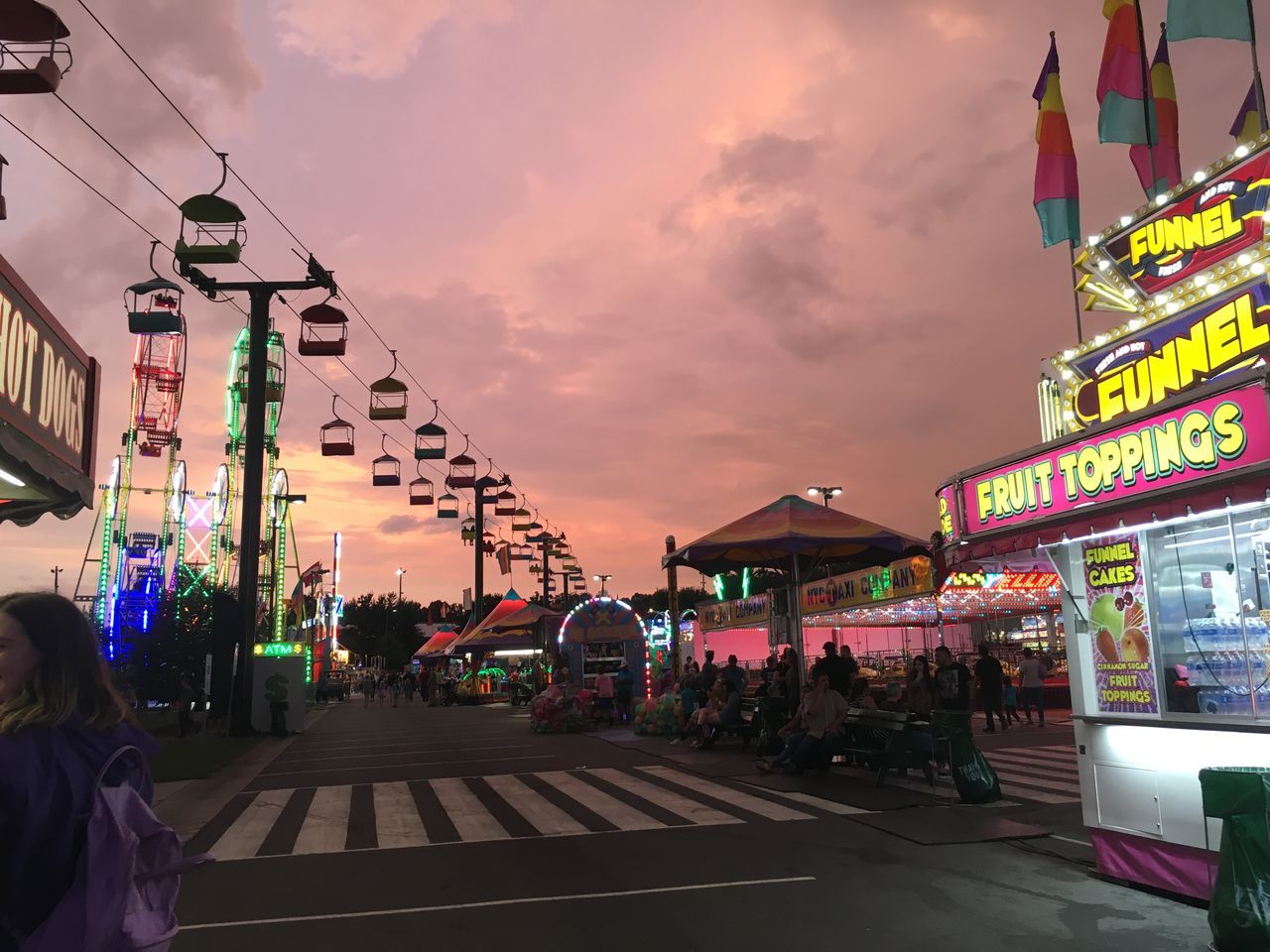 architecture, sky, street, built structure, building exterior, city, cloud - sky, group of people, incidental people, sunset, real people, women, lifestyles, crowd, adult, large group of people, nature, illuminated, lighting equipment, outdoors, street market