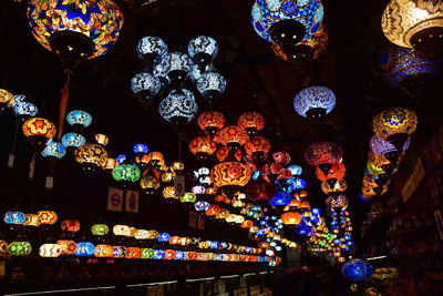 Low angle view of illuminated chandelier at night