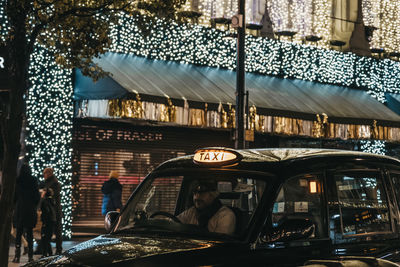 People sitting in city seen through glass building