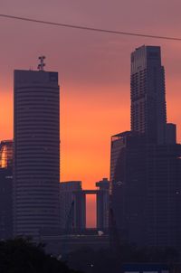 Silhouette buildings against sky during sunset