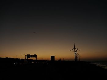 Silhouette of wind turbines at sunset