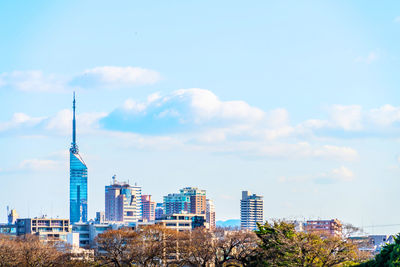 Modern buildings in city against sky