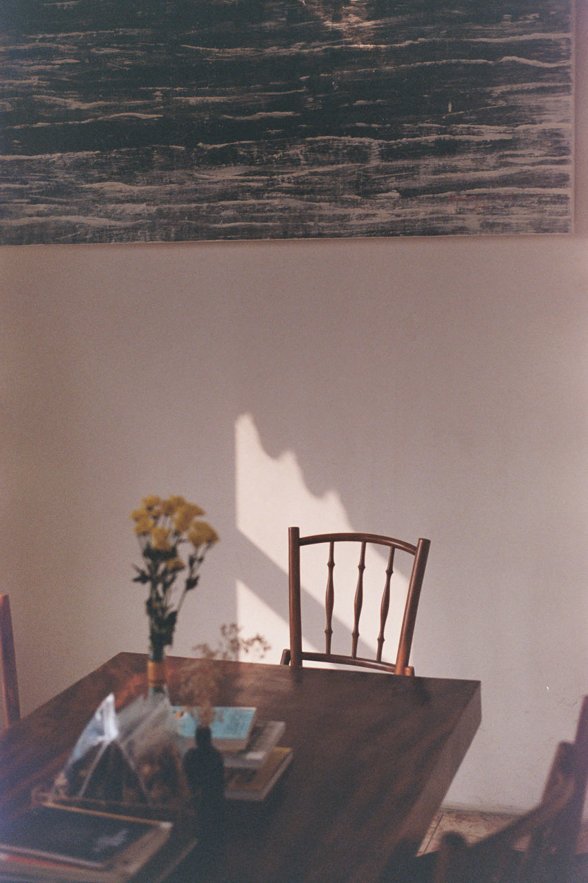 CLOSE-UP OF EMPTY CHAIR ON TABLE AT HOME