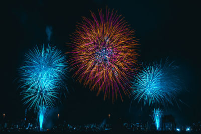 Low angle view of firework display at night