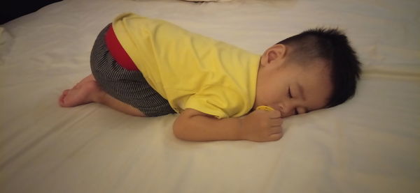 Cute boy sleeping on bed