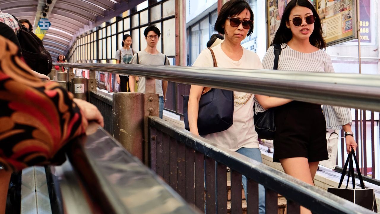 WOMAN STANDING IN RAILING