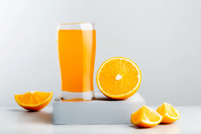 Yellow and orange juice on table