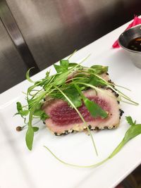 Sesame coated a heat tuna topped with greens