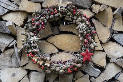 Advent wreath in front of an stack of wood 