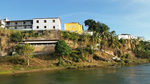 architecture, building exterior, built structure, water, tree, house, waterfront, sky, residential structure, residential building, clear sky, river, reflection, day, canal, nature, grass, plant, outdoors, no people