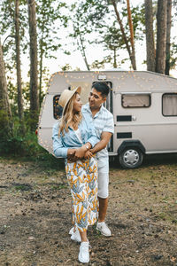 Married asian couple in love travel by camper car on a road trip in nature on their honeymoon