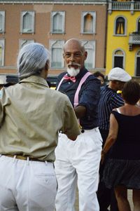 Rear view of people on street in city