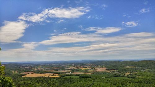 Scenic view of landscape against blue sky