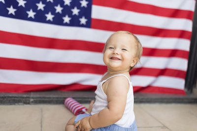 Portrait of cute girl holding american flag