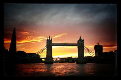 Bridge over river at sunset