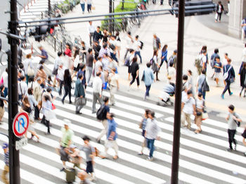 Blurred image of people walking on street in city