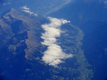 Aerial view of mountains against blue sky