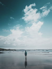 Man standing on beach against sky