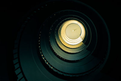 Directly below shot of illuminated spiral staircases