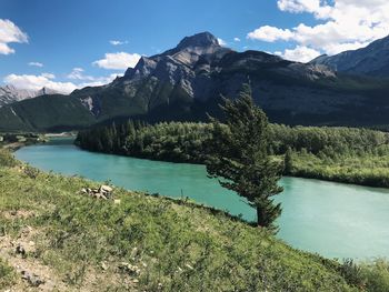 Scenic view of lake and mountains against sky