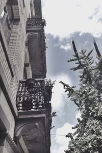 Low angle view of building against cloudy sky