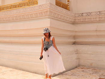 Full length of young woman standing in temple