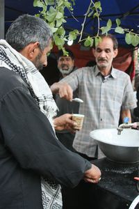 Happy friends standing by food outdoors