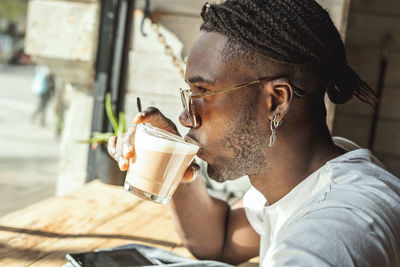 Side view of a man drinking coffee