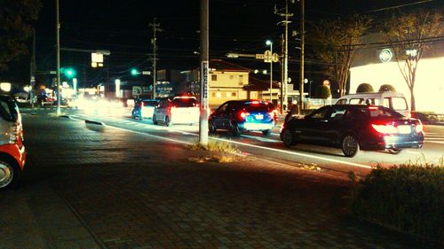 Cars on road in city at night