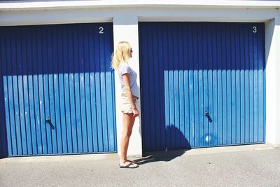 Full length of woman standing by railing