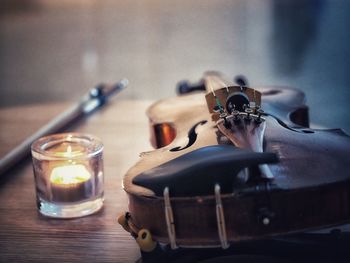 Violin and a candela on the table