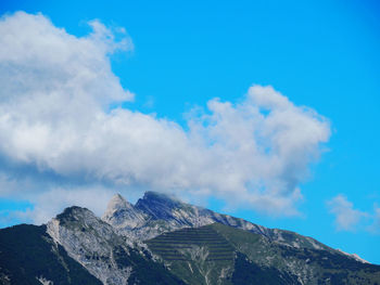 Low angle view of mountains against blue sky