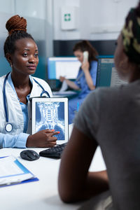 Doctor talking with patient in clinic