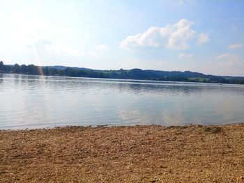 Scenic view of lake against cloudy sky