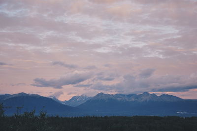 Scenic view of mountains against cloudy sky