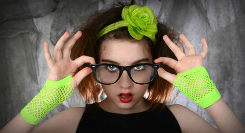 Close-up portrait of confident teenage girl wearing eyeglasses