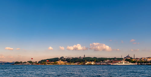 Panoramic view of sea and buildings against sky