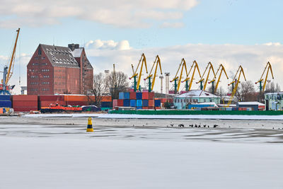 Massive harbor cranes in seaport. heavy load dockside cranes in port, cargo container ship terminal