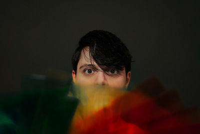 Close-up portrait of man against black background