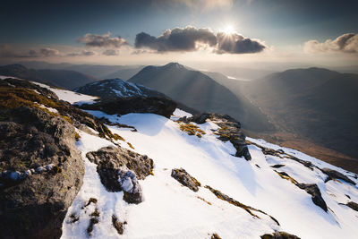 Panoramic view of mountains against sky during winter