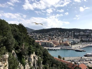Aerial view of nice townscape by sea against sky with bord and mountains