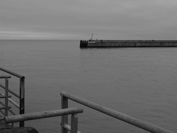 Pier on sea against sky