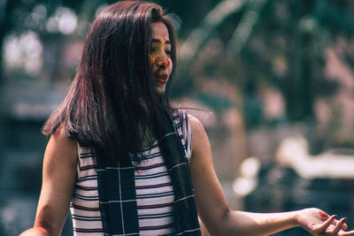 Young woman with powder paint on face during holi