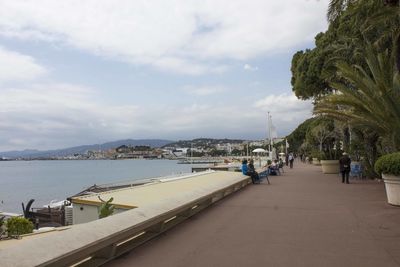 Scenic view of sea by city against sky