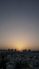 Cityscape against sky during sunset